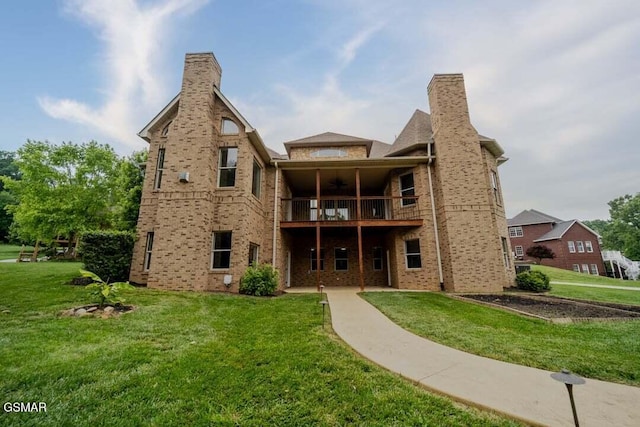 118 Luxury Ln, Dandridge, TN 37725 - rear view of property with ceiling fan, a balcony, a lawn, and brick siding