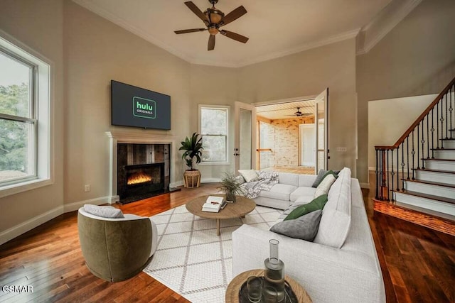 118 Luxury Ln, Dandridge, TN 37725 - living room with wood finished floors, crown molding, a tile fireplace, a ceiling fan, and baseboards