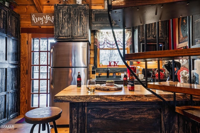 kitchen featuring wood finished floors and freestanding refrigerator