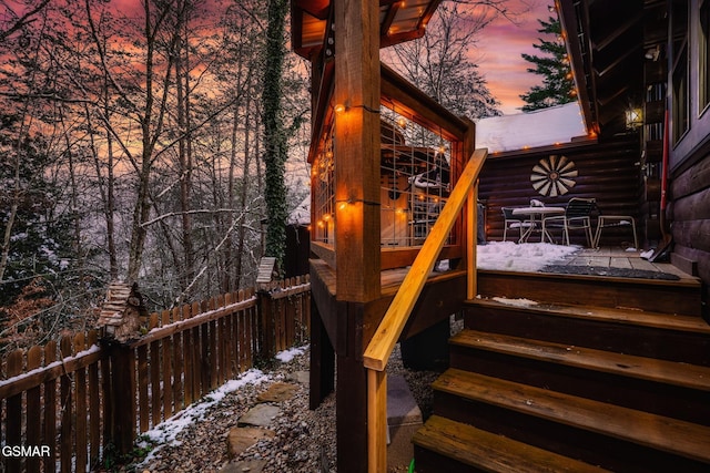 snow covered deck featuring fence private yard