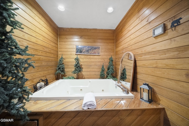 bathroom with wood walls and a tub with jets