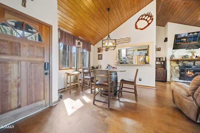 dining room featuring wood ceiling, baseboards, and a chandelier