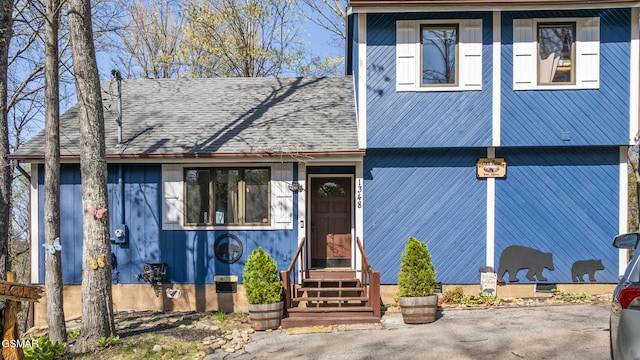 view of front of property featuring entry steps and a shingled roof