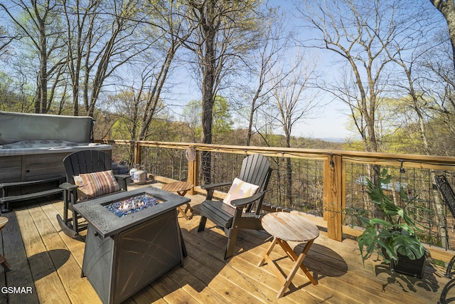 deck with a fire pit and a hot tub