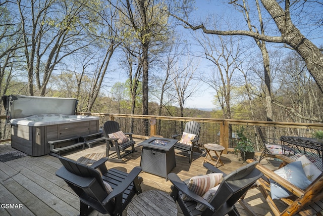 wooden deck featuring a fire pit and a hot tub