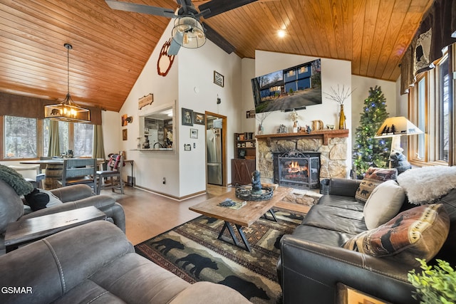 living room featuring baseboards, plenty of natural light, and wood ceiling