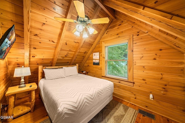 bedroom featuring vaulted ceiling with beams, ceiling fan, wood walls, and wooden ceiling