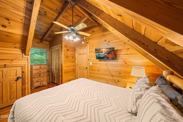 bedroom with vaulted ceiling with beams, ceiling fan, wood walls, and wood ceiling