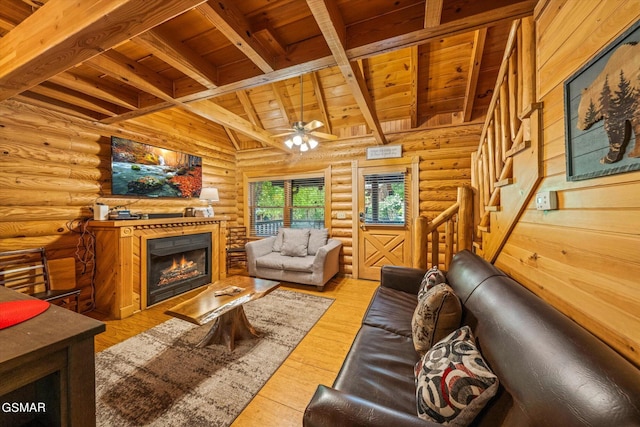 living room with rustic walls, light hardwood / wood-style flooring, ceiling fan, and wooden ceiling