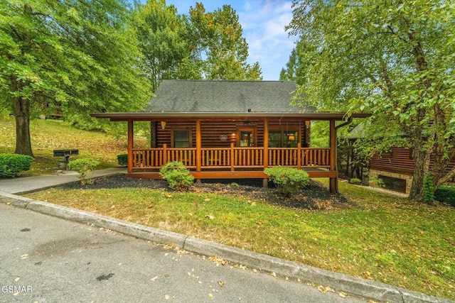 log cabin featuring a front lawn