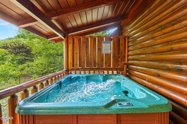 view of pool with a hot tub