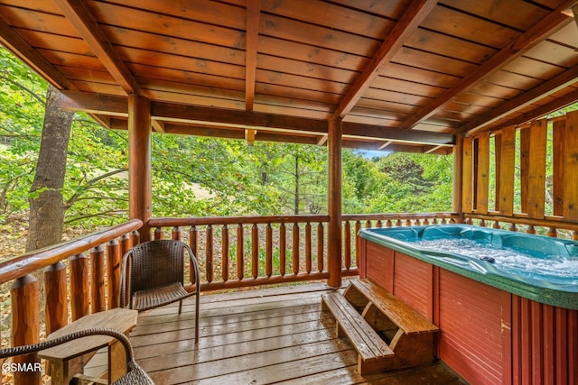 wooden deck featuring a hot tub