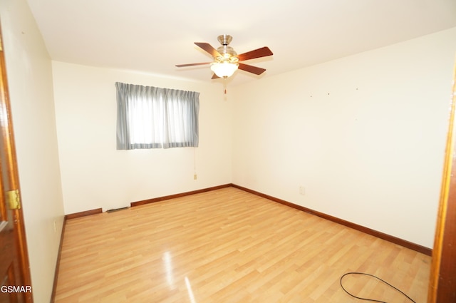 empty room featuring hardwood / wood-style flooring and ceiling fan