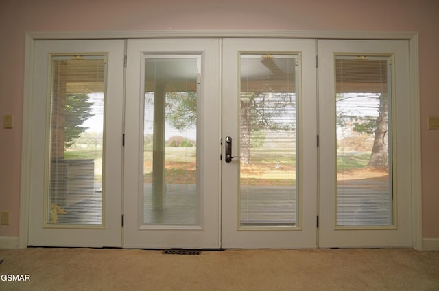 doorway with light colored carpet and french doors