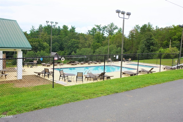 view of pool featuring a lawn