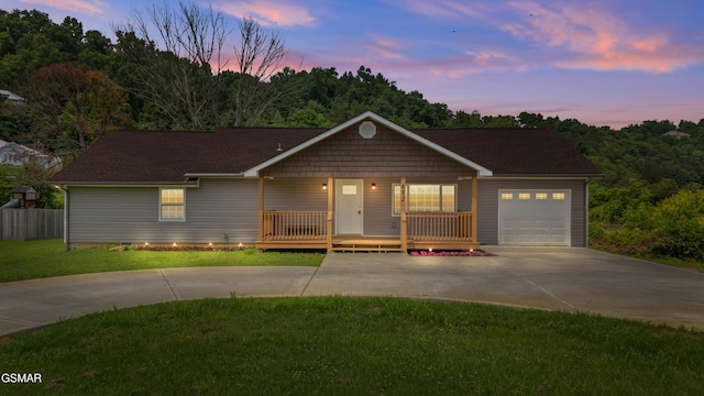 412 Apple Valley Rd, Sevierville, TN 37862 - ranch-style home with concrete driveway, covered porch, an attached garage, and a front lawn