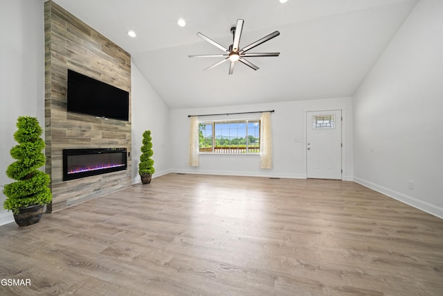 412 Apple Valley Rd, Sevierville, TN 37862 - unfurnished living room featuring vaulted ceiling, a ceiling fan, a fireplace, wood finished floors, and recessed lighting
