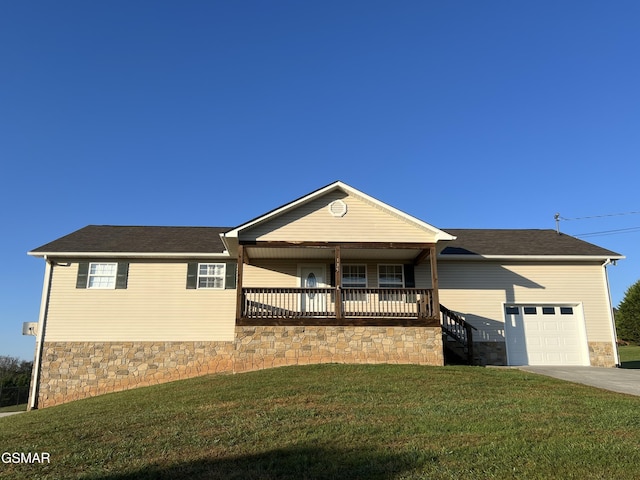 single story home featuring covered porch, a front yard, and a garage