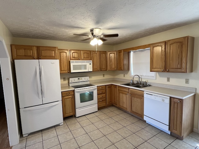 kitchen with a textured ceiling, white appliances, ceiling fan, sink, and light tile patterned floors