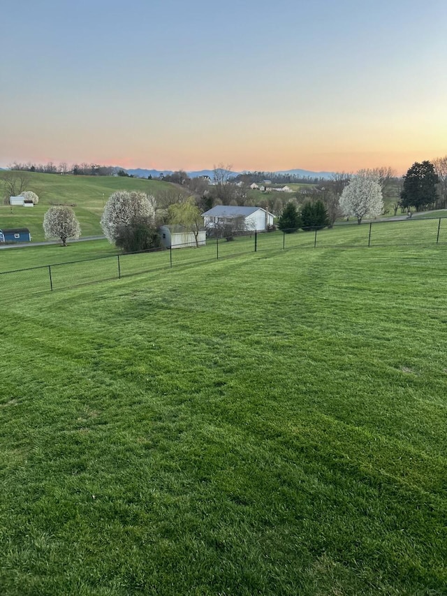 yard at dusk with a rural view