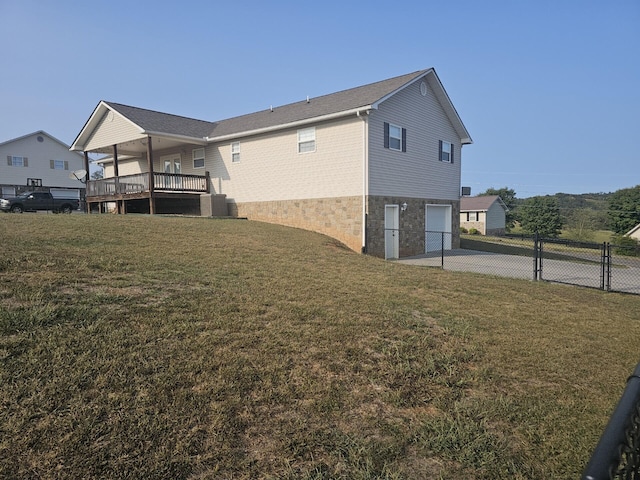 view of side of home with a yard and a garage