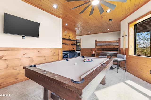 game room featuring ceiling fan, wood walls, light colored carpet, wood ceiling, and pool table