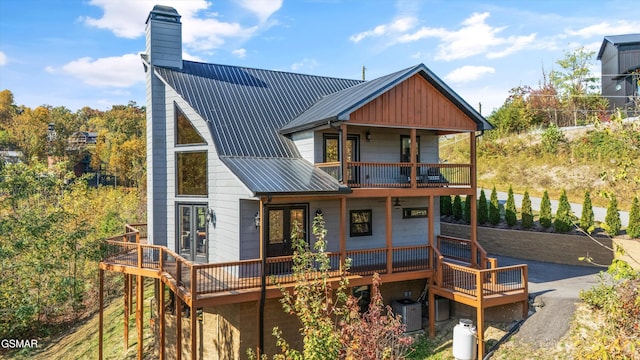 rear view of property with french doors and central air condition unit