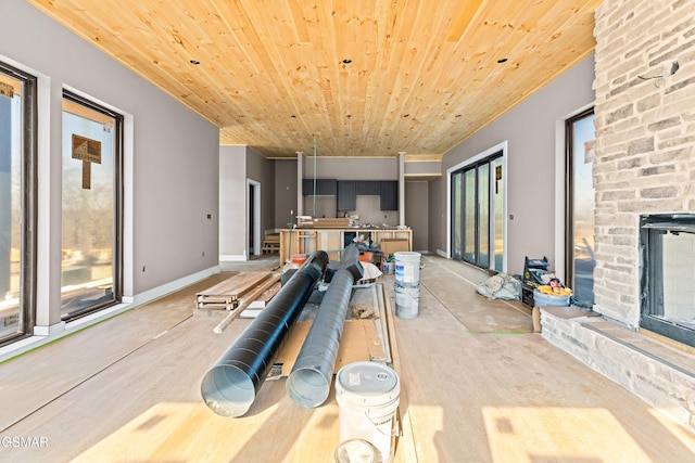 recreation room with wood ceiling and a fireplace