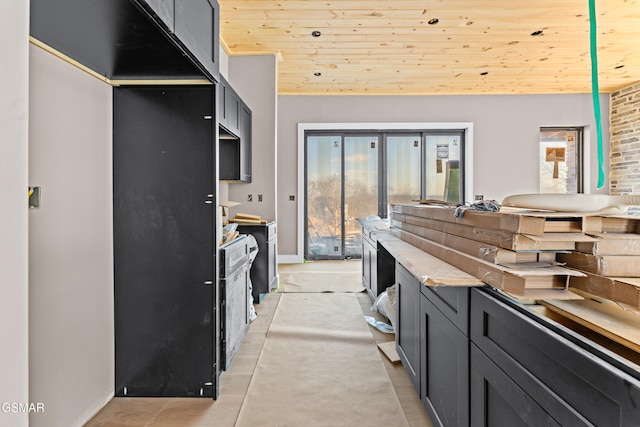 kitchen with vaulted ceiling, a healthy amount of sunlight, and wood ceiling