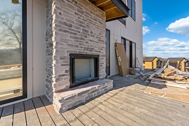 wooden deck featuring a fireplace