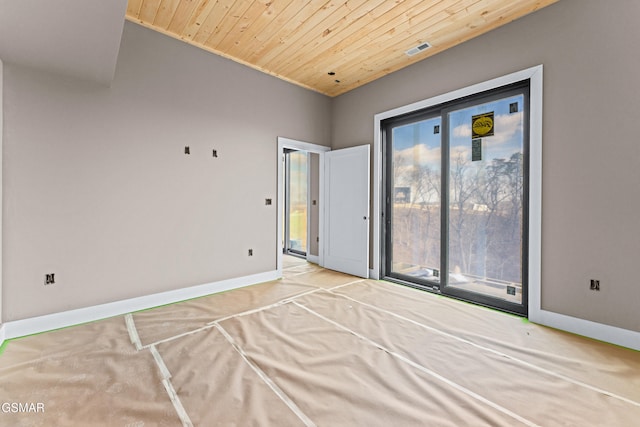 unfurnished bedroom featuring access to exterior and wooden ceiling