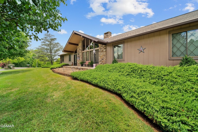 1505 Canterbury Ln, Sevierville, TN 37862 - view of side of property with a chimney, a yard, stone siding, and board and batten siding