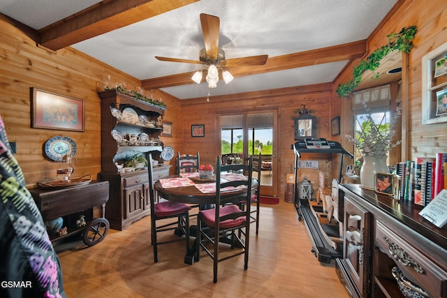 1505 Canterbury Ln, Sevierville, TN 37862 - dining space featuring healthy amount of natural light, wood walls, beam ceiling, ceiling fan, and light wood-style flooring