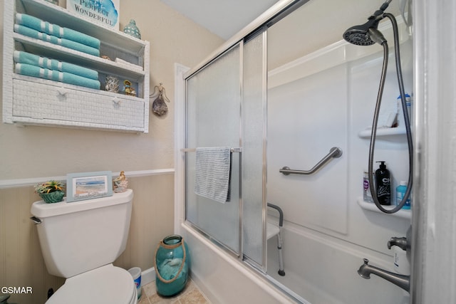 1505 Canterbury Ln, Sevierville, TN 37862 - bathroom featuring enclosed tub / shower combo, a wainscoted wall, and tile patterned floors