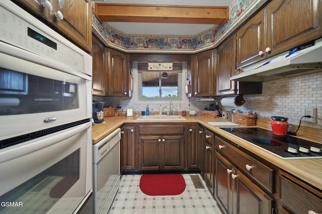 1505 Canterbury Ln, Sevierville, TN 37862 - kitchen featuring white appliances, under cabinet range hood, light countertops, and tasteful backsplash