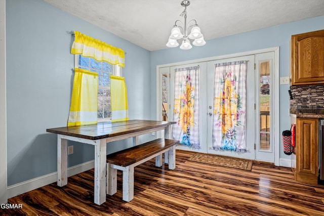 dining space with an inviting chandelier, baseboards, french doors, and dark wood-style floors