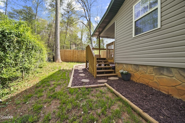 view of yard with fence and a wooden deck