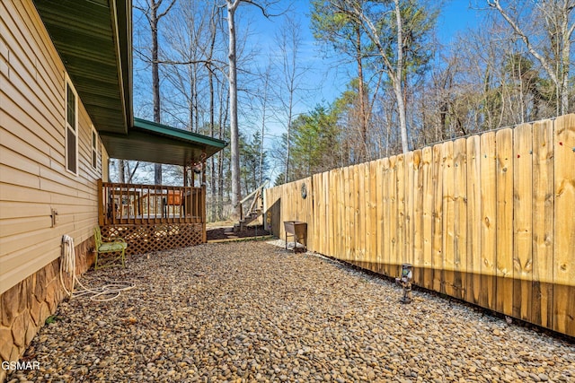 view of yard featuring fence and a deck