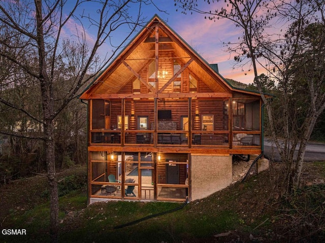 view of back house at dusk