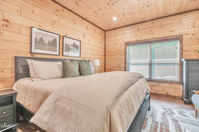 bedroom featuring wood walls, wood finished floors, and wood ceiling