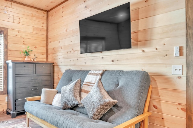 sitting room with wood walls and wood finished floors