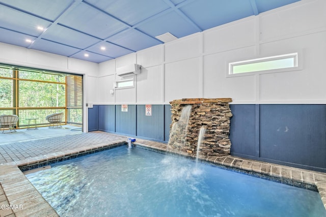 view of swimming pool featuring a wall unit AC