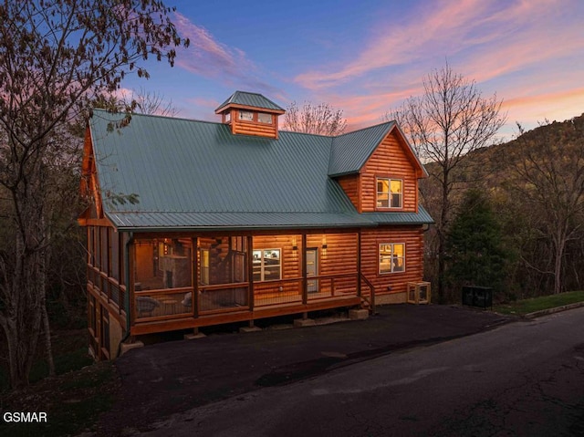 view of front facade with covered porch, metal roof, and a mountain view