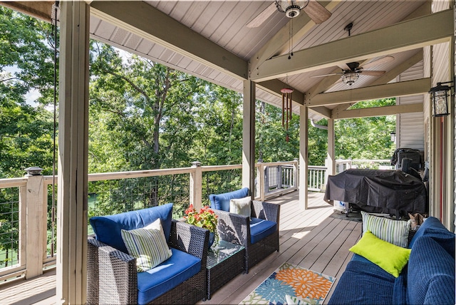 wooden deck with area for grilling and ceiling fan