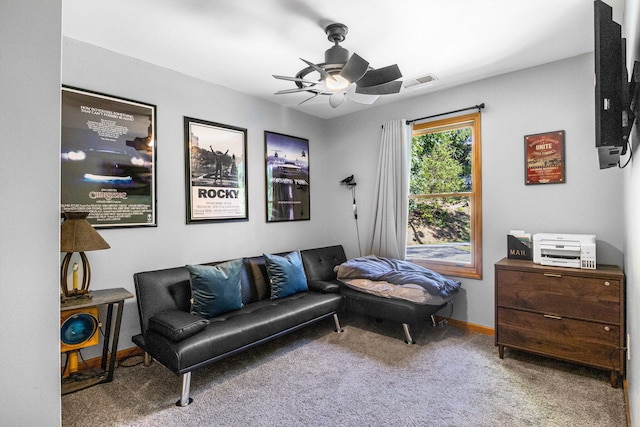 living area featuring carpet flooring and ceiling fan