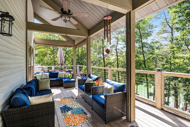 wooden terrace featuring an outdoor living space and ceiling fan