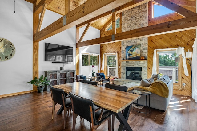 dining space with a fireplace, dark hardwood / wood-style flooring, high vaulted ceiling, and a healthy amount of sunlight