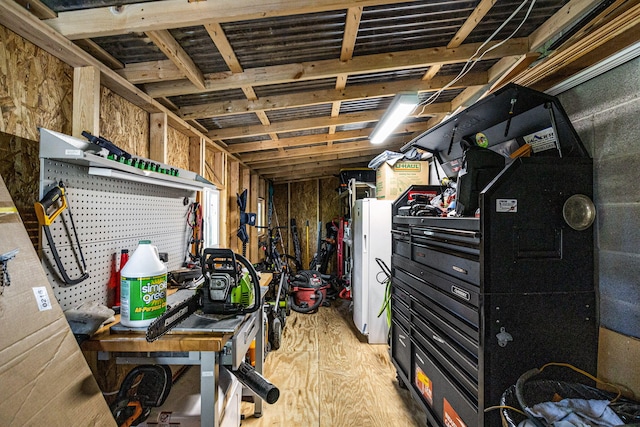 basement with a workshop area and light hardwood / wood-style flooring