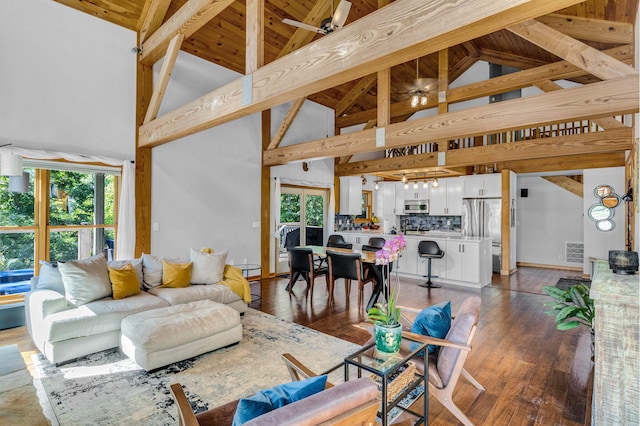 living room with beam ceiling, high vaulted ceiling, and hardwood / wood-style flooring