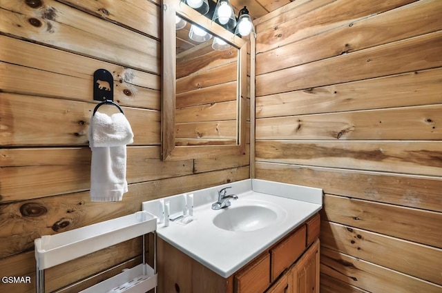 bathroom featuring wooden walls and vanity